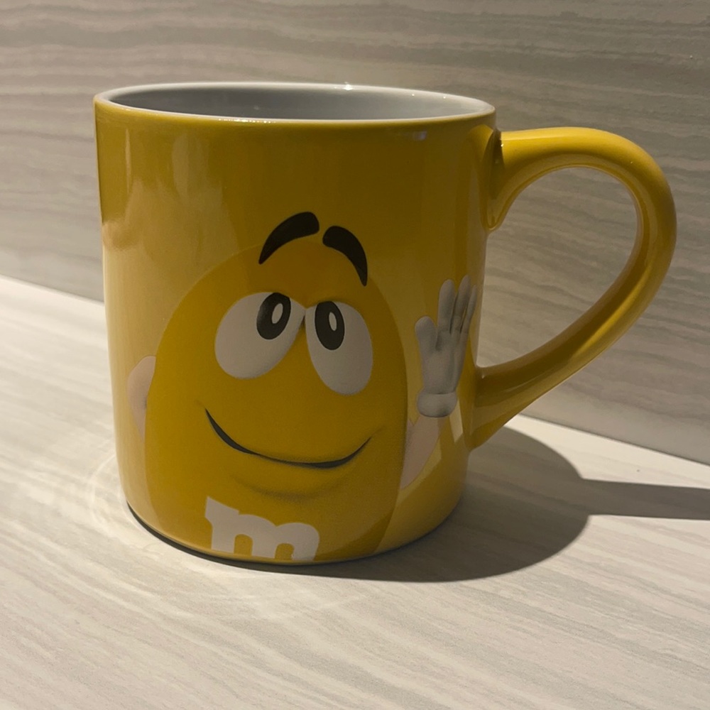 M&M yellow mug - “Inside everyone there’s a little NUT”